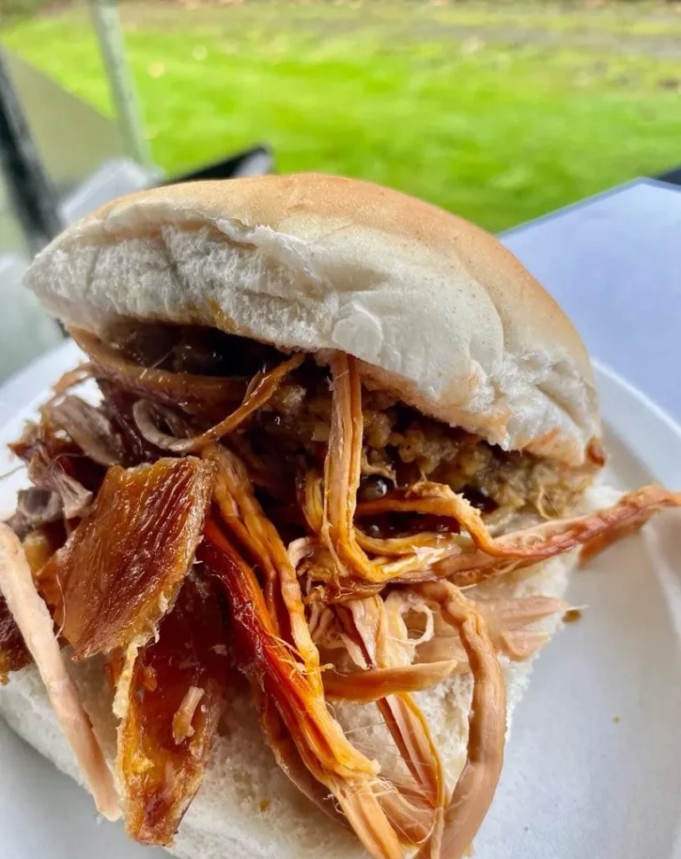 Hog roast bread roll filled with shredded pork, crispy crackling and stuffing